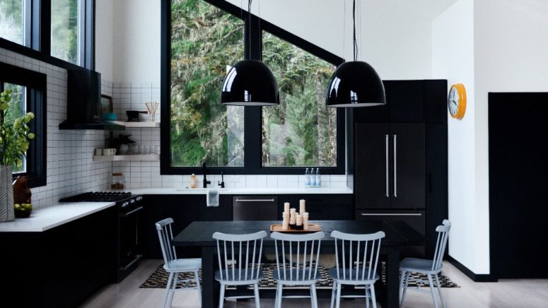 The dining room and kitchen space is done in a monochromatic color scheme, it's black and white