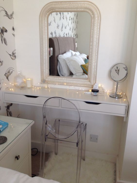 a built-in dressing table of an Ekby Alex shelf in the corner and an acrylic chair