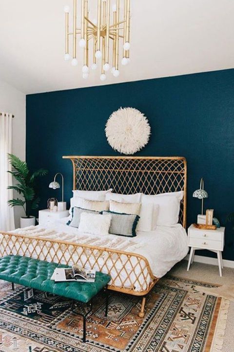 a neutral bedroom can be spruced up with a navy statement wall for a chic and bold look