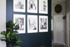 03 a statement navy wall with a gallery wall of black and white family photos