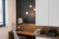 04 a home office nook is visually separated from the rest of the space with a black statement wall