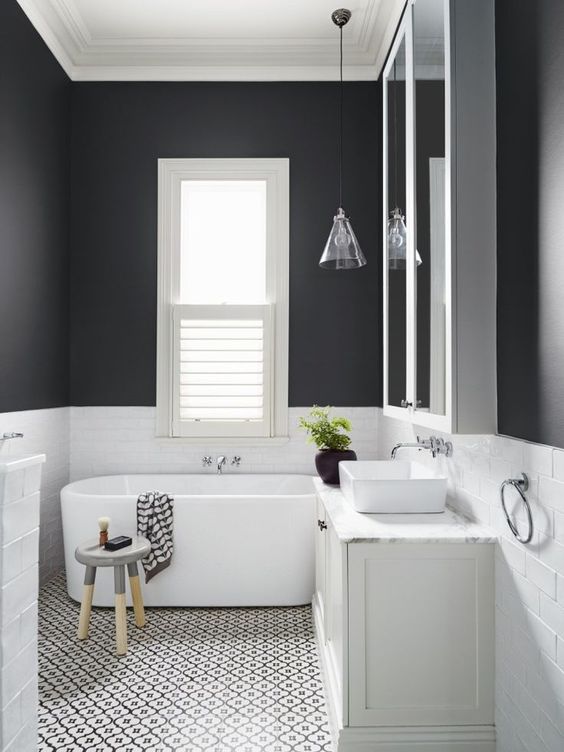 black walls clad with white tiles create a monochromatic yet catchy and contrasting look