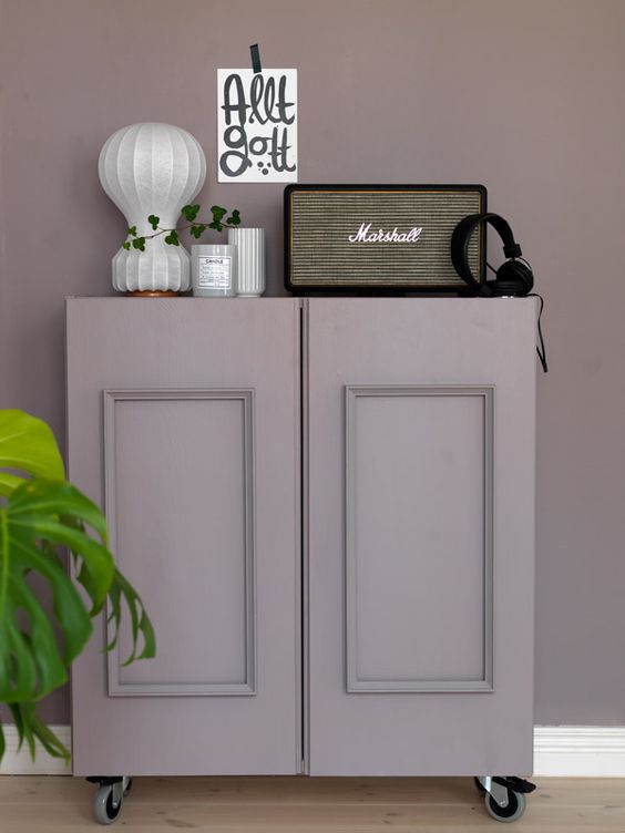 IKEA Ivar cabinet done with paneling, painted dusty lilac and placed on casters for a vintage feel