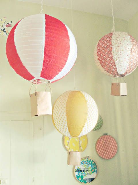 An arrangement of hanging lamps   colorful hot air balloons made of IKEA Regolit lampshades