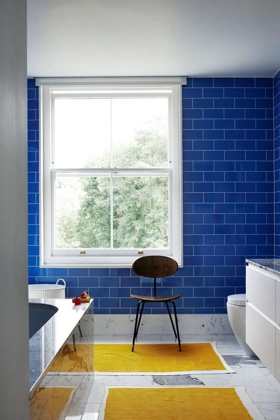 bold blue subway tiles on the wall make a statement and add an edge as subway tiles are a hot trend