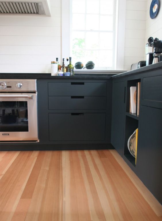 Douglas fir wood floor and graphite grey kitchen cabinets create a bold and chic modern look