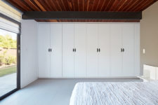 06 The master bedroom is very laconic, it’s done in white with a large bed, some cabinets and bedside tables