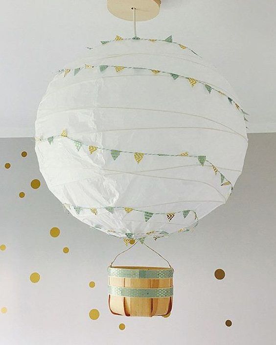 an IKEA Regolit lampshade with colorful bunting and a little basket makes up a gorgeous hot air balloon lamp