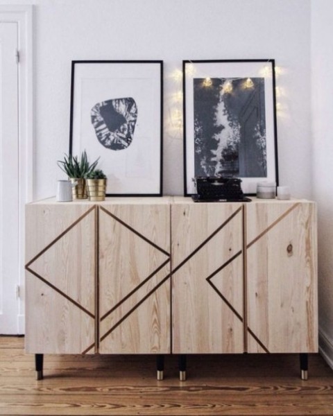 Ivar cabinets decorated with geometric patterns made with masking tape and black and gold legs