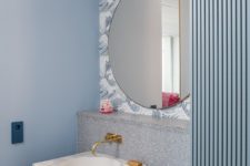 07 The bathroom features greys and blues, there’s stone, terrazzo, wallpaper and paint to bring more textures in