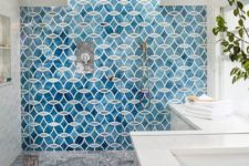 07 a bold blue mosaic tile statement wall in the shower is a bold idea to add color and pattern to the bathroom