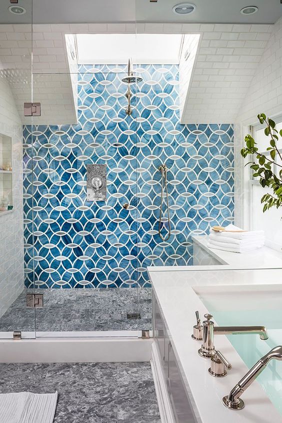a bold blue mosaic tile statement wall in the shower is a bold idea to add color and pattern to the bathroom
