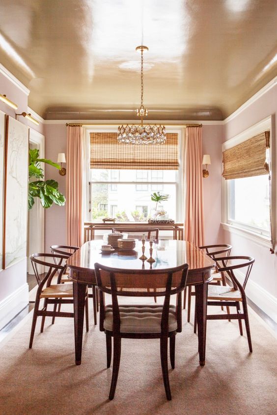 A copper dining room ceiling keeps the space warm colored and peachy while adding a shiny touch to it