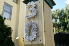 07 a post with metal nails that form house numbers is a stylish and bold idea with an industrial feel