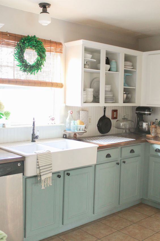 mint and white kitchen cabinet make up a relaxed space with a vintage feel