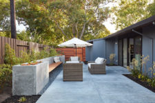 08 The outdoor space is done with wicker furniture, an umbrella and a concrete bench with built-in planters