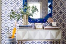 08 a bold blue printed wallpaper statement wall and a matching urn and mirror for a wow effect