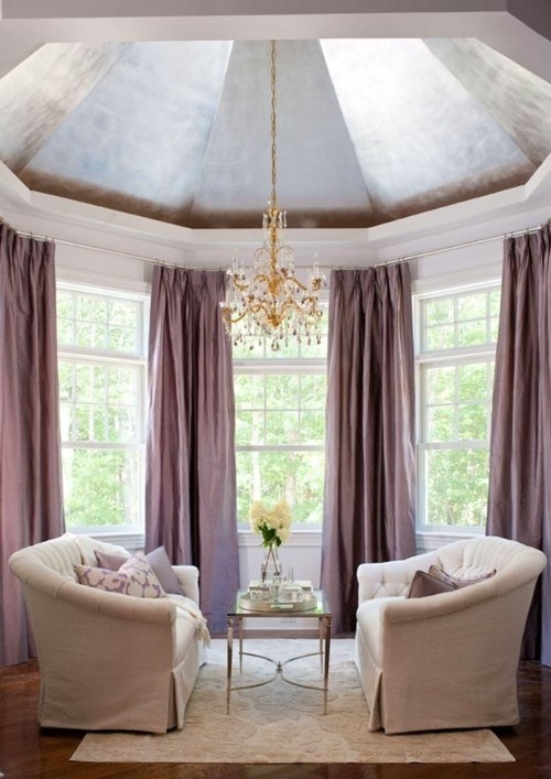 a cozy awkward nook with a domed ceiling and a skylight plus metallic cover on the ceiling