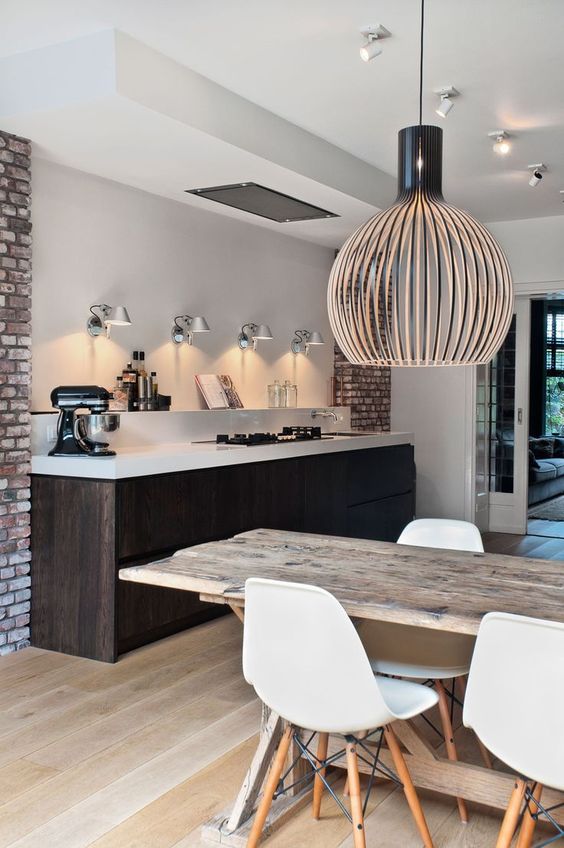 a dark stained kitchen island is a dominant piece in the whole space, it makes a statement