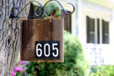 08 a house number sign hanging from a tree is a stylish vintage-inspired idea for any home