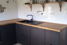 08 matte black cabinets with wooden countertops are a bold and modern idea