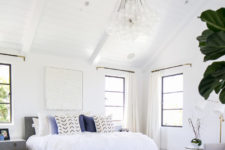 09 The master bedroom is very chic and cozy, done in blue and white with lots of texture done with textiles