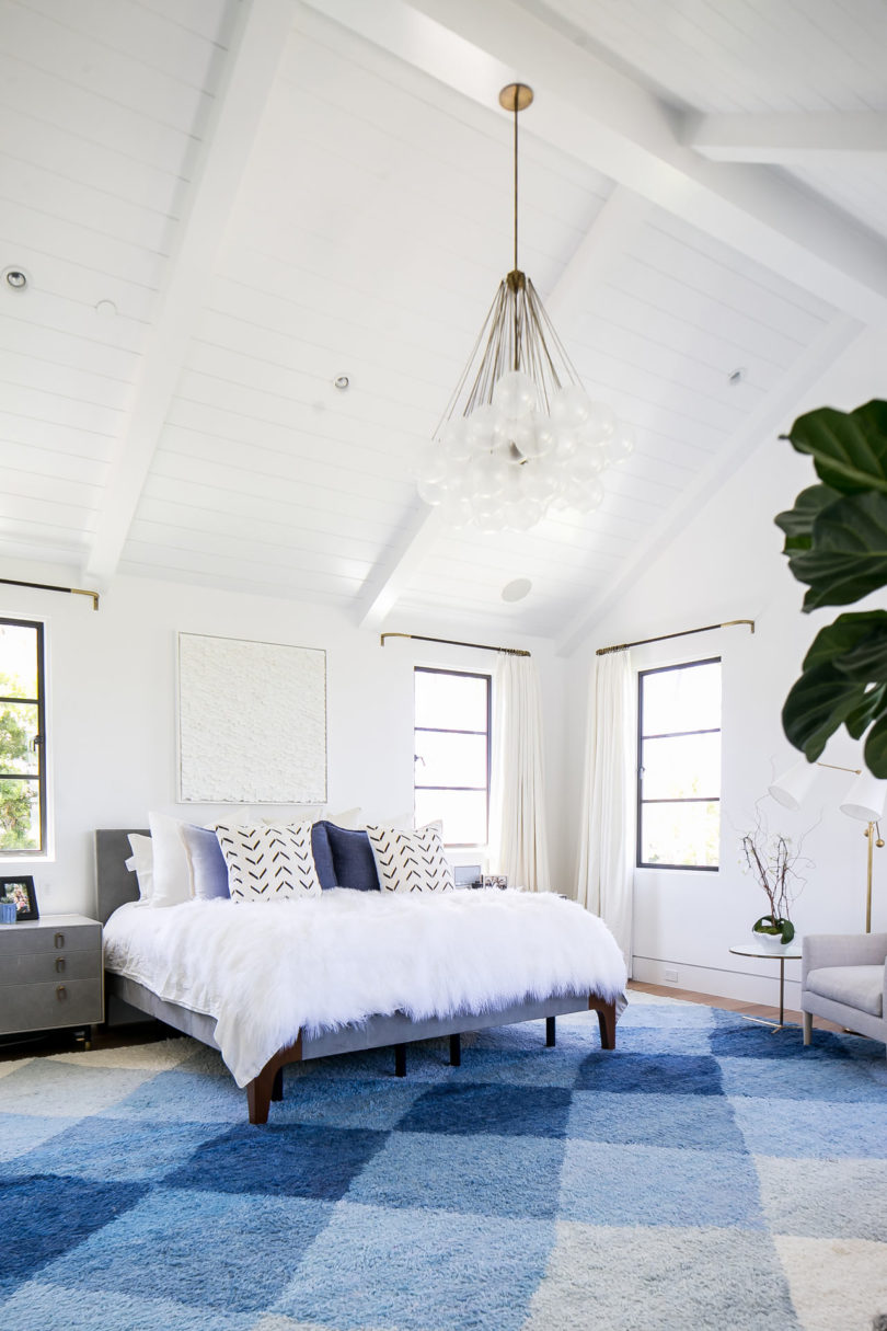 The master bedroom is very chic and cozy, done in blue and white with lots of texture done with textiles