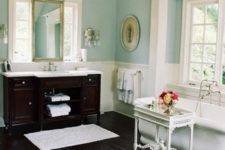 09 a dark stained floor and a matching vanity are of a dominant dark tone, and the rest of the furniture is whitewashed