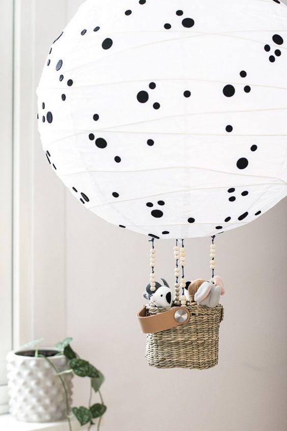 a Regolit lampshade turned into a hot air balloon lamp with polka dots and toys in the basket