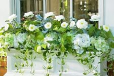 10 a chic white window box planter with white flowers and cascading greenery brings ultimate elegance