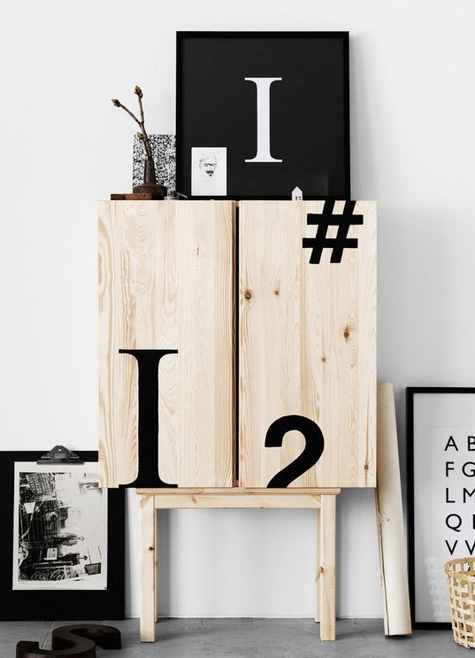 an IKEA Ivar cabinet decorated with black typography looks very bold and modern