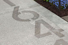 10 house numbers stenciled into the side walk is a simple and very modern idea, which fits contemporary and minimalist homes