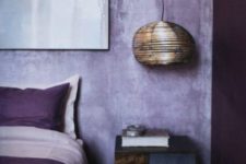 10 lilac plaster walls and touches of deep purple make up a bold and ultra modern bedroom