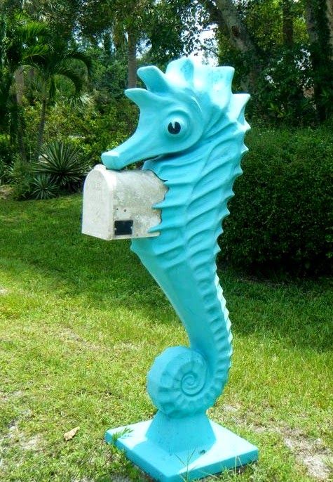 a bright turquoise seahorse mailbox is a bold and whimsy idea for a coastal or beach home