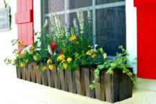 11 a dark stained picket fence flower box with colorful blooms is a bold idea and red shutters add to the look