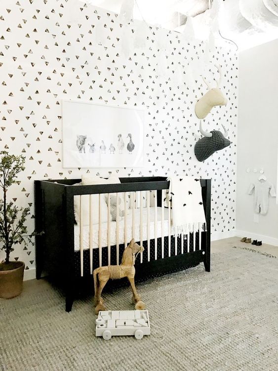 a bold and chic black and white crib is a statement idea for a monochromatic nursery like this one