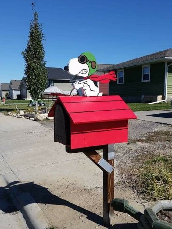 a hot red mailbox with a fun toon doggie is a whimsy and quriky idea that will catch an eye every time