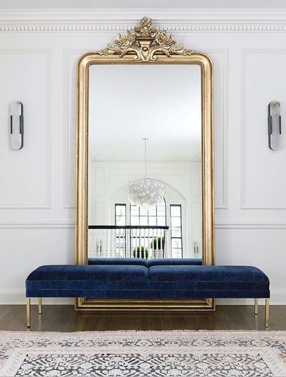a beautiful navy velvet bench with gold legs is a refined and chic statement for the entryway