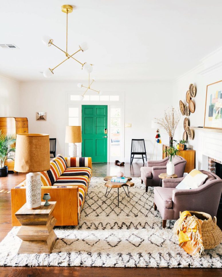 a bright mid-century modern living room with a duo of lilac chairs that feature muted colors