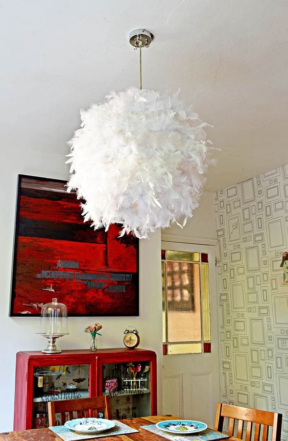 a feather lampshade made of an IKEA Regolit lampshade to add a touch of glam and softness to your space
