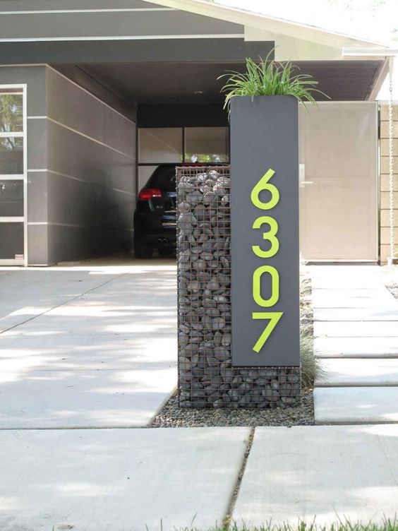 A grey sign with neon green numbers looks ultra modern and bold and hints on the contemporary decor inside