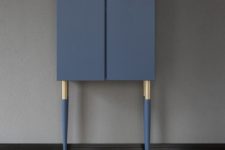14 a very chic and refined hack of an Ivar cabinet in navy, with tall gold and navy legs and gold knobs