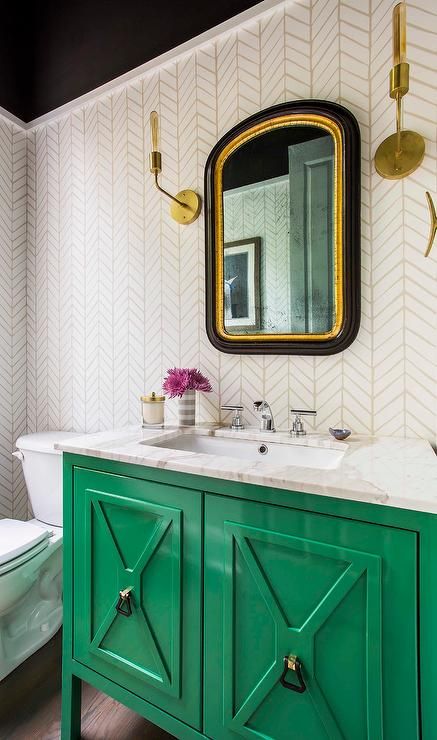 an emerald vanity with a white marble countertop is a chic and bright accent in the bathroom