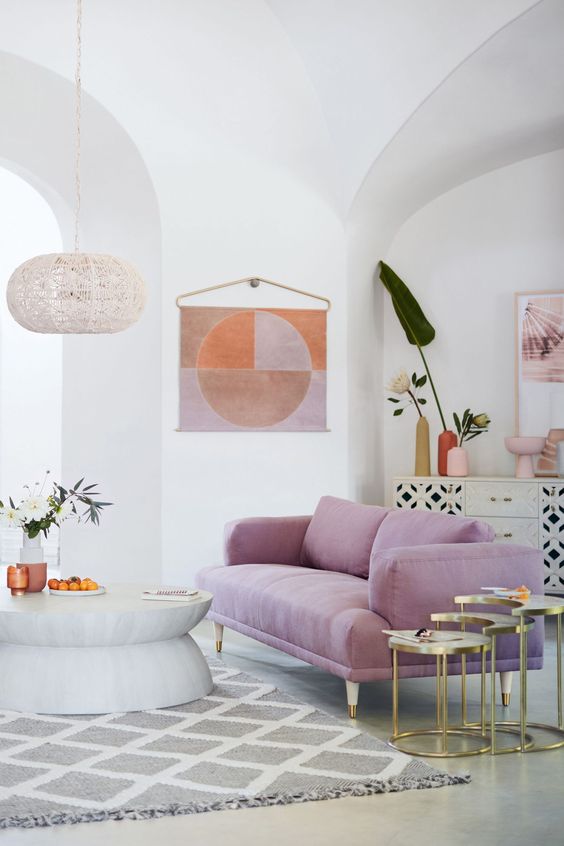 a contemporary living room done in neutrals and with a lilac sofa as a bright touch and centerpiece
