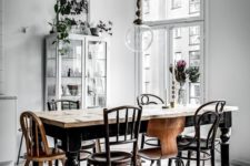 15 a gorgeous vintage Scandinavian dining space with mismatching wood chairs and a table plus a light-colored wood floor
