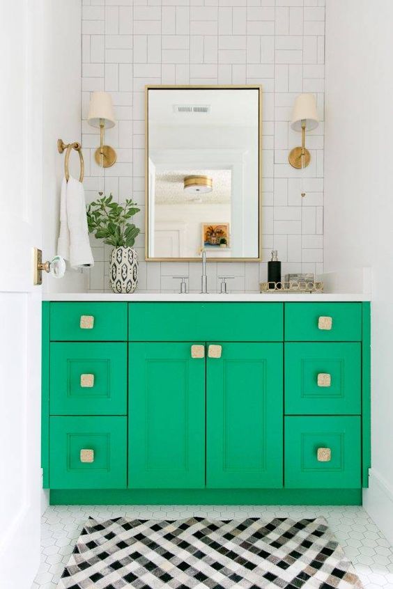 a bright green vanity with square handles and brass touches is a super bold idea to spruce up a neutral space