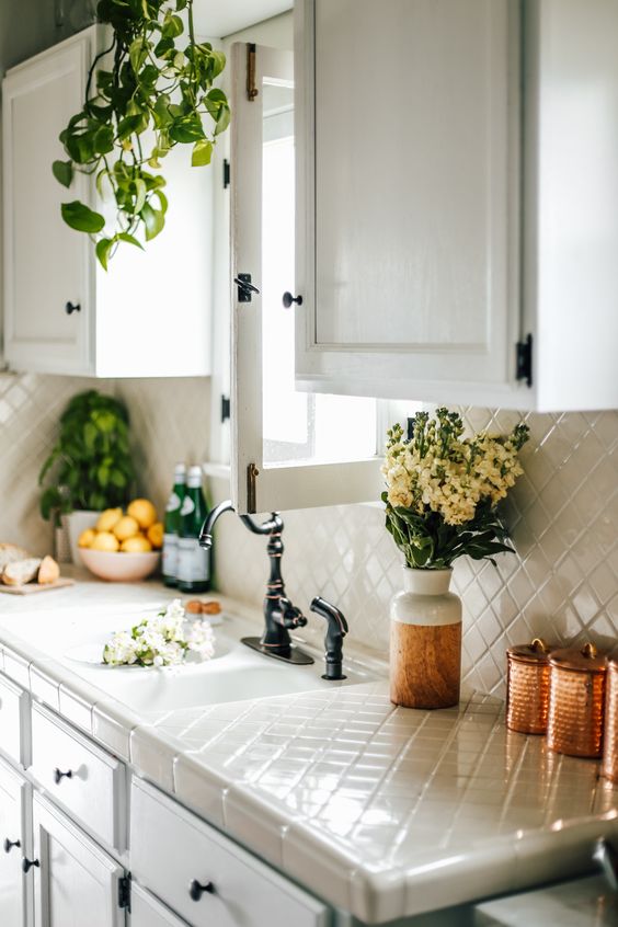 the same tiles for the backsplash and countertops is a whimsy and durable idea to try