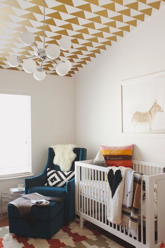A geometric ceiling in gold and white done with stickers is an easy idea to spruce up a nursery with no fuss