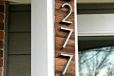 17 a stylish modern house number display with rich-colored wooden planks and modern numbers attached to the corner of the house
