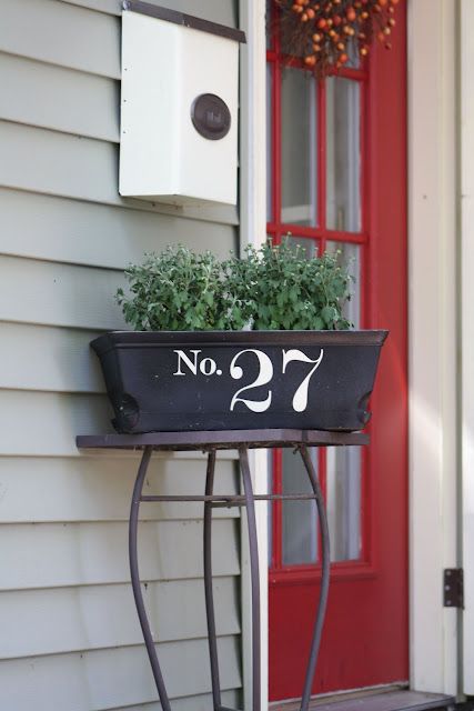 stencil or apply vinyl numbers to a planter box next to the front door, this is a quick DIY project with a cool look